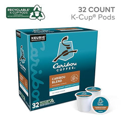 Box of Caribou Coffee K-Cup pods with two pods displayed in front on a white background.