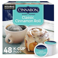 Box of Cinnabon Classic Cinnamon Roll K-Cup pods with a cup of coffee and cinnamon roll on a white background.