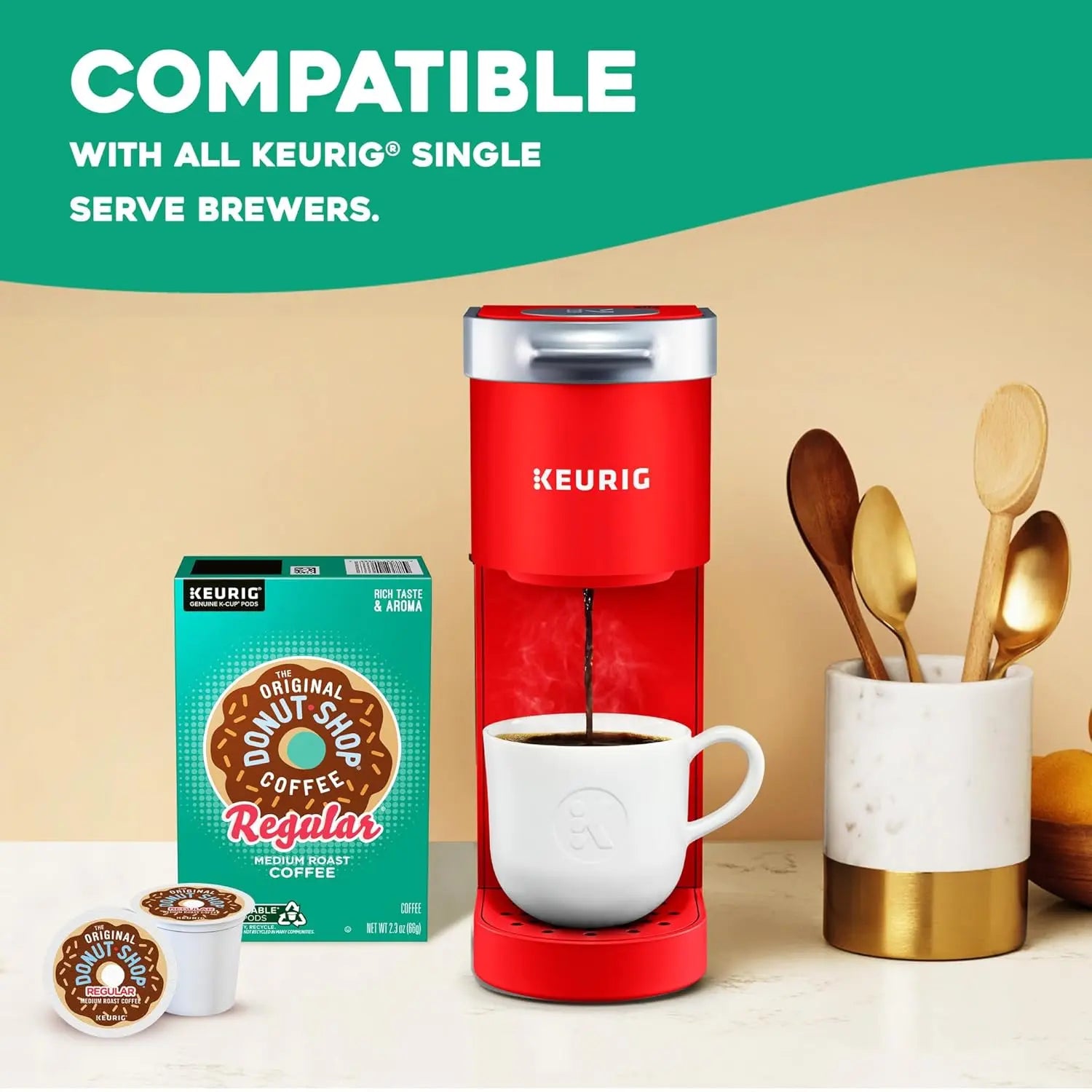 Red Keurig coffee maker with a white mug, Donut Shop coffee box, and K-cups on a beige background.