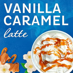 Vanilla caramel latte with whipped cream and caramel drizzle on a blue background