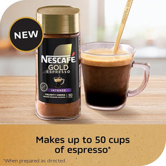 Nescafe Gold Espresso bottle with a glass of espresso on a wooden surface