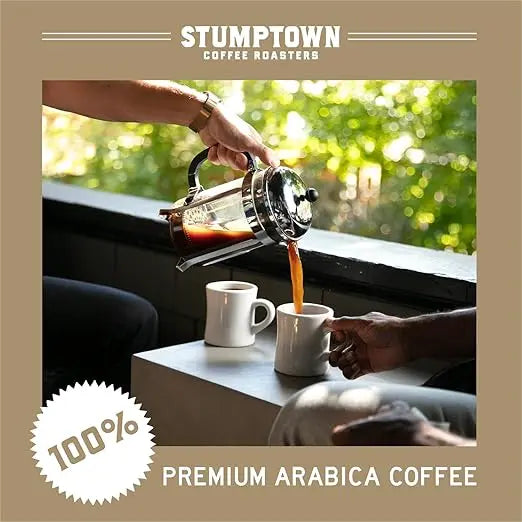Person pouring coffee from a French press into a white mug with Stumptown Coffee Roasters branding.