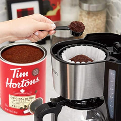 Person measuring Tim Hortons coffee into a coffee maker