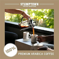 Person pouring coffee from a French press into a white mug with Stumptown Coffee Roasters branding.